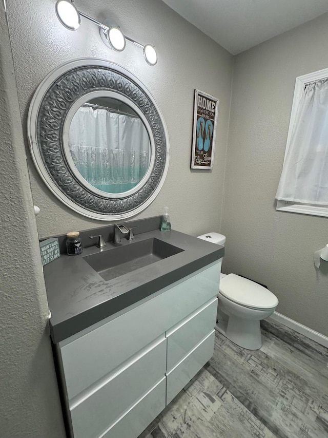 1630 3rd St N, Fargo, ND 58102 - bathroom with vanity, wood finished floors, and a textured wall