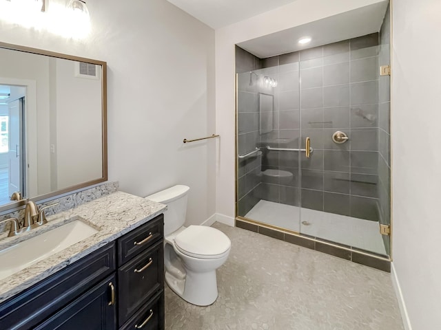 bathroom with tile patterned floors, vanity, toilet, and a shower with door