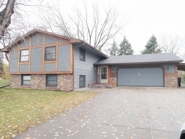 split level home featuring a front yard and a garage