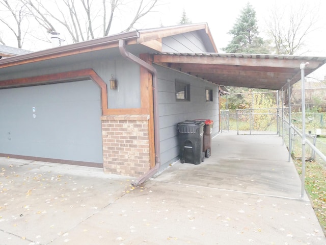 view of home's exterior featuring a garage and a carport