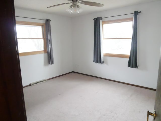 spare room with carpet floors and ceiling fan