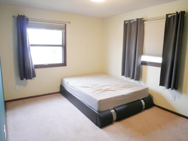 bedroom with light colored carpet