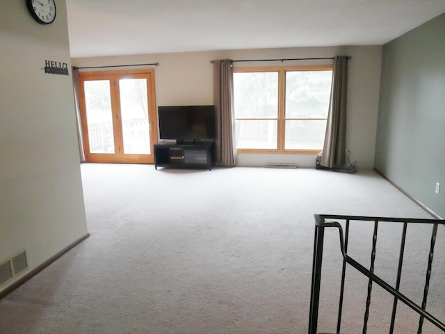 unfurnished living room featuring carpet