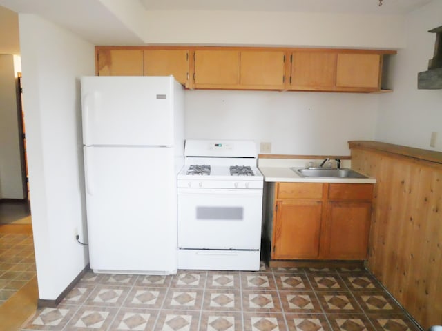 kitchen featuring white appliances, sink, and light tile patterned floors