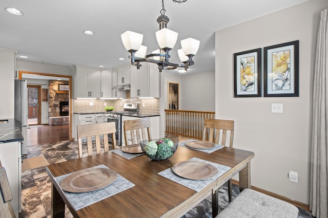 dining space with dark wood-type flooring and an inviting chandelier