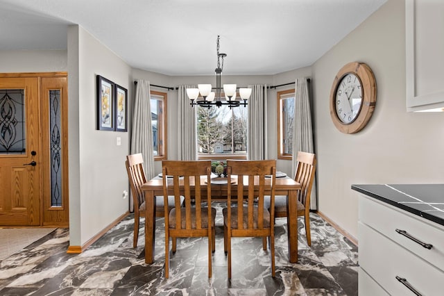 dining area with an inviting chandelier