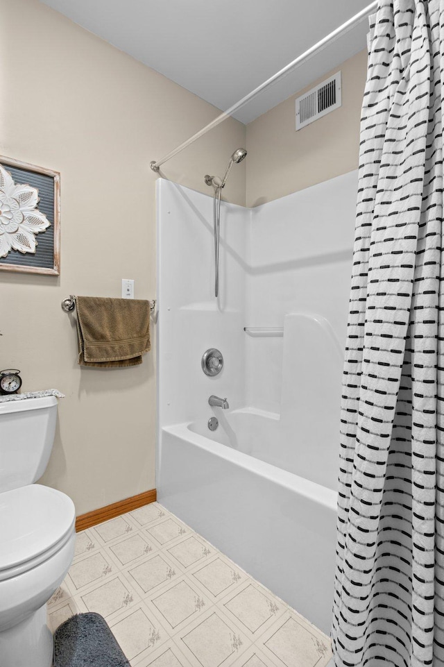 bathroom featuring shower / bath combination with curtain and toilet