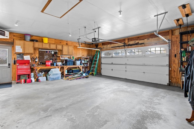 garage featuring a garage door opener and a workshop area