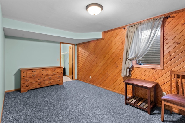 living area with carpet flooring and wood walls