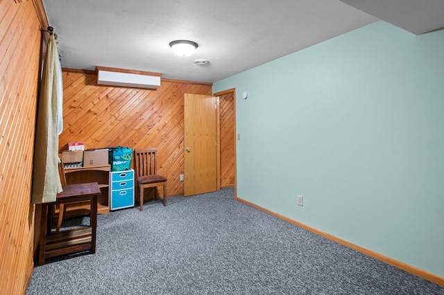 interior space featuring dark colored carpet and wood walls