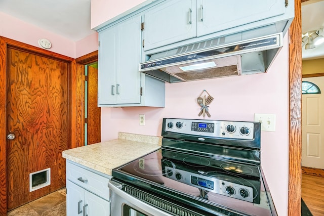 kitchen with light countertops, stainless steel electric range, visible vents, and under cabinet range hood