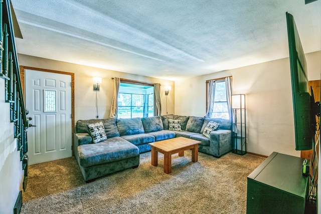 carpeted living room featuring a textured ceiling