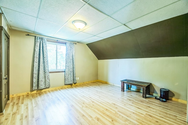 bonus room featuring vaulted ceiling, wood finished floors, and baseboards