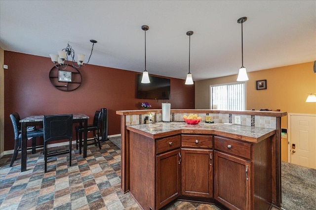 kitchen with a chandelier, pendant lighting, and a kitchen island