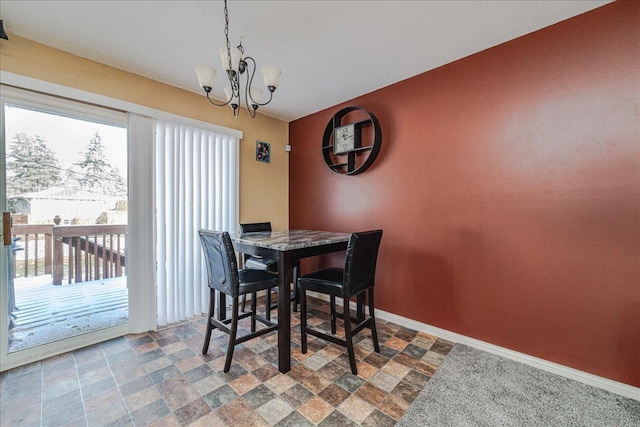 dining space featuring a notable chandelier