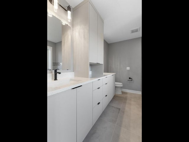 bathroom with tile patterned floors, vanity, and toilet