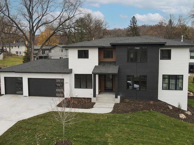 view of front of house featuring a garage and a front lawn