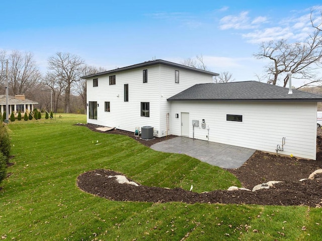 rear view of house with central air condition unit, a yard, and a patio