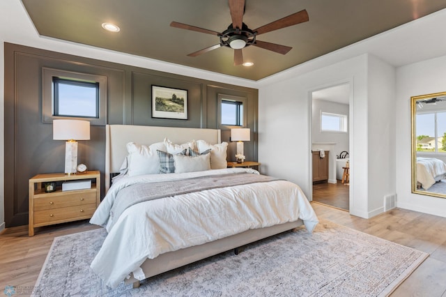 bedroom with multiple windows, ceiling fan, and light hardwood / wood-style flooring