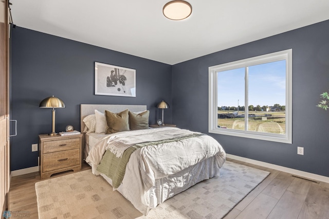 bedroom with light hardwood / wood-style floors