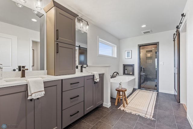 bathroom with vanity, plus walk in shower, and tile patterned flooring