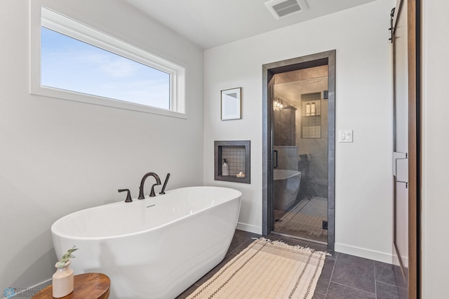 bathroom with tile patterned flooring and independent shower and bath