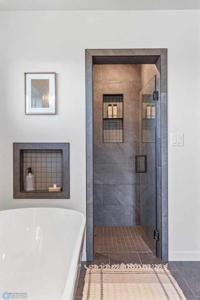 bathroom featuring tile patterned floors and shower with separate bathtub