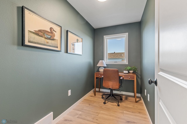 office with light wood-type flooring