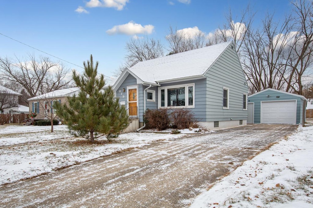 view of front of property featuring an outbuilding and a garage