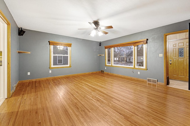 unfurnished living room featuring light hardwood / wood-style floors and ceiling fan