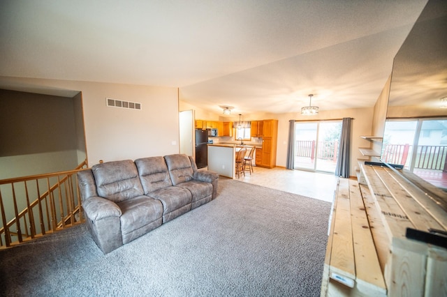 carpeted living room featuring vaulted ceiling