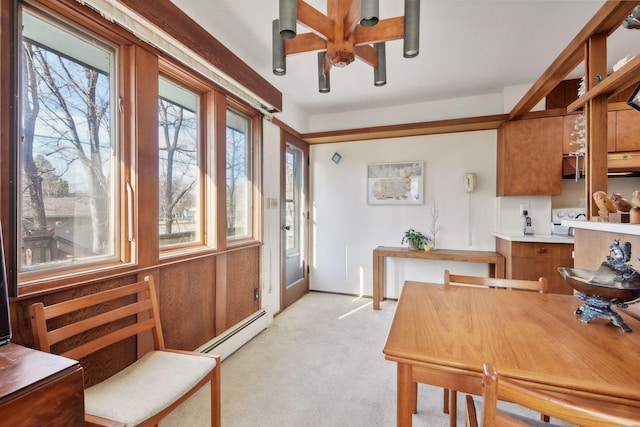 interior space with ceiling fan, light colored carpet, and baseboard heating