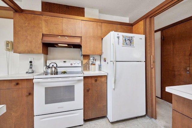 kitchen with white appliances and a textured ceiling