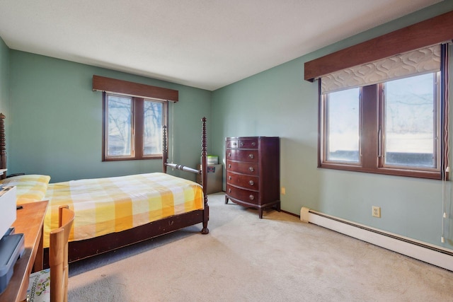 carpeted bedroom with a baseboard heating unit