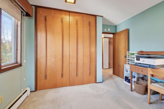 carpeted bedroom featuring a closet and a baseboard heating unit