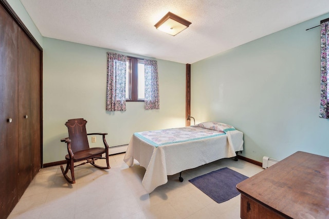 bedroom featuring a closet, a baseboard radiator, and a textured ceiling