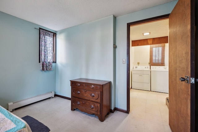 bedroom featuring a textured ceiling, ensuite bathroom, separate washer and dryer, and baseboard heating