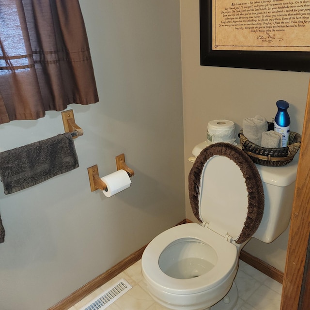 bathroom featuring tile patterned flooring and toilet