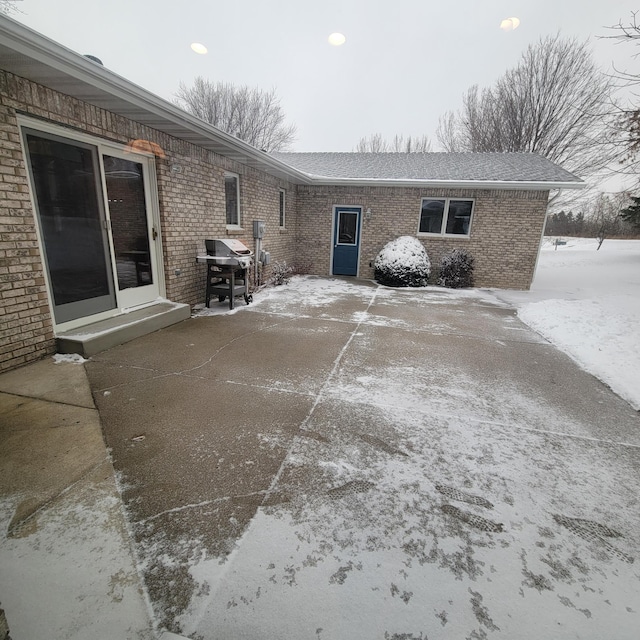 snow covered patio featuring grilling area