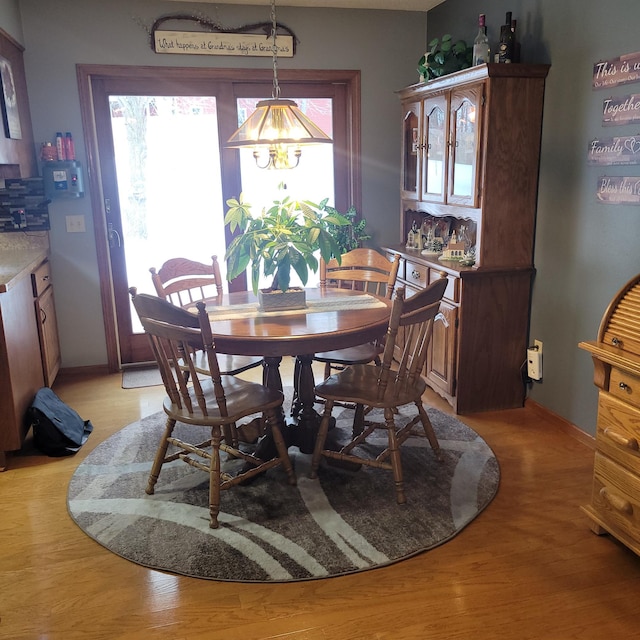 dining space featuring light wood-style floors