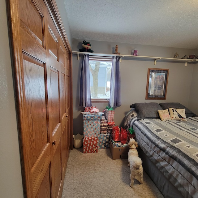 carpeted bedroom featuring a textured ceiling