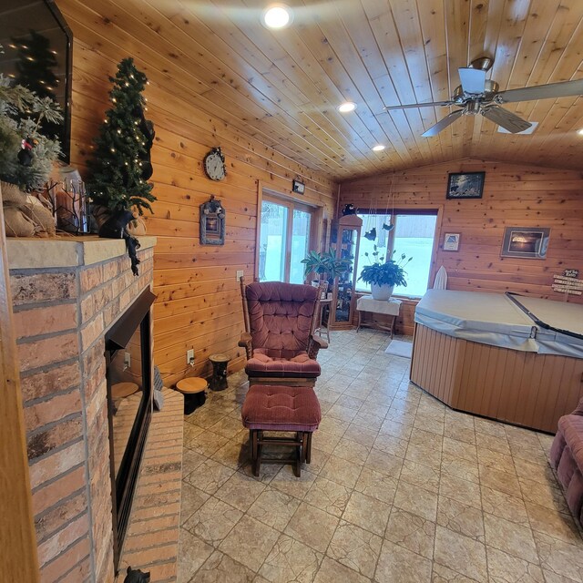 interior space featuring a fireplace, lofted ceiling, recessed lighting, wood ceiling, and wood walls