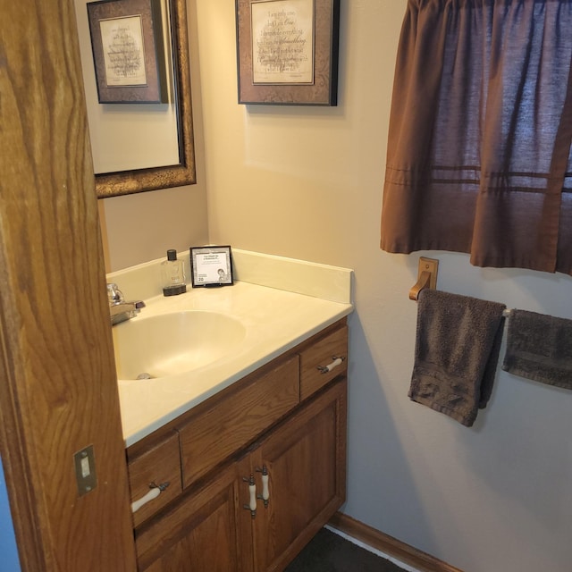 bathroom featuring baseboards and vanity