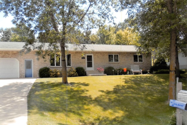 ranch-style home with driveway, brick siding, a front lawn, and an attached garage