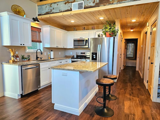 44811 County Highway 14, Perham, MN 56573 - kitchen featuring white cabinets, appliances with stainless steel finishes, a kitchen island, and dark wood-type flooring