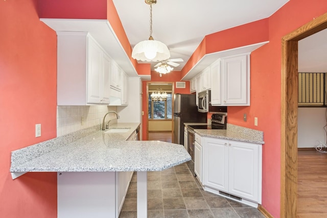 kitchen featuring appliances with stainless steel finishes, ceiling fan, sink, decorative light fixtures, and white cabinets