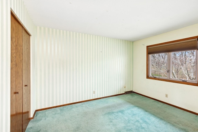 unfurnished bedroom with carpet flooring and a closet