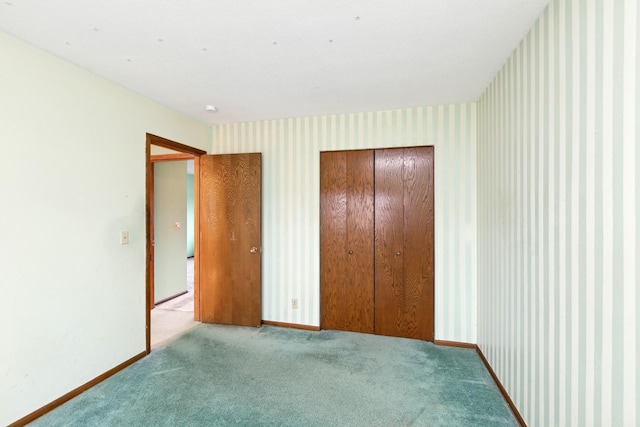 unfurnished bedroom featuring a closet and light colored carpet