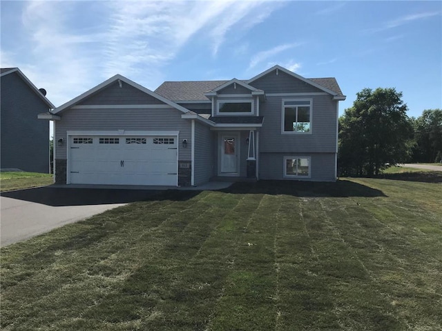 view of front of property featuring a garage and a front lawn