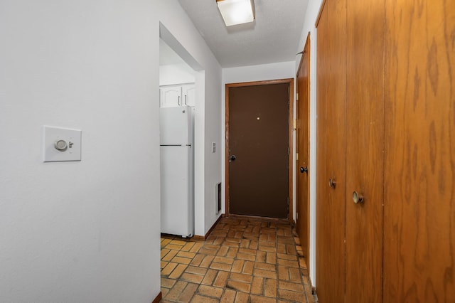 hallway featuring a textured ceiling